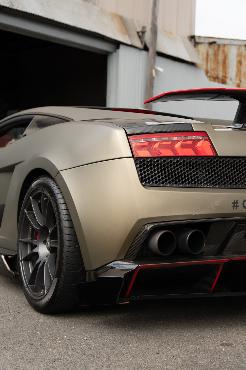 Rear of the Lamborghini outside a workshop