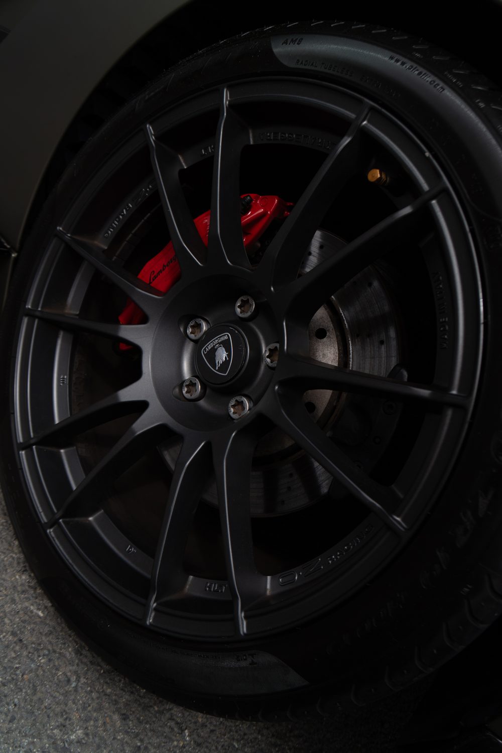 Close-up of a black wheel and red brake caliper
